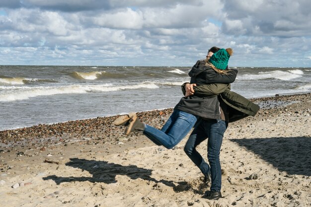 young couple of the cold Baltic sea