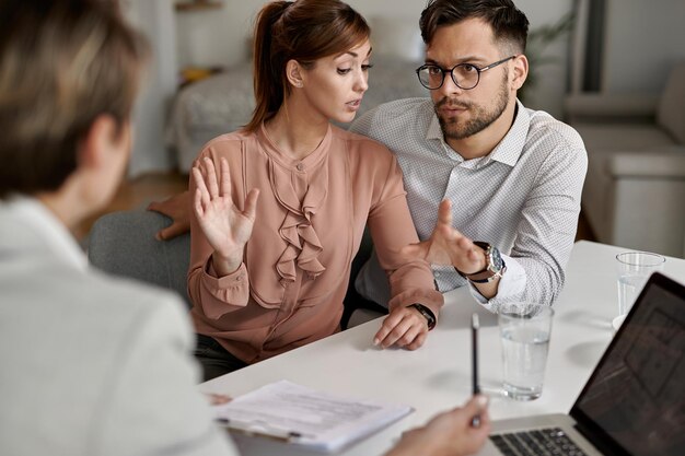 Young couple communicating with insurance agent during a meeting