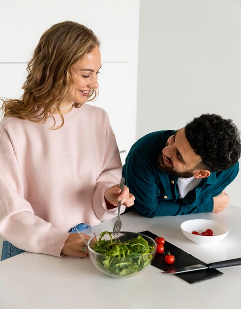 Young couple cooking at home together