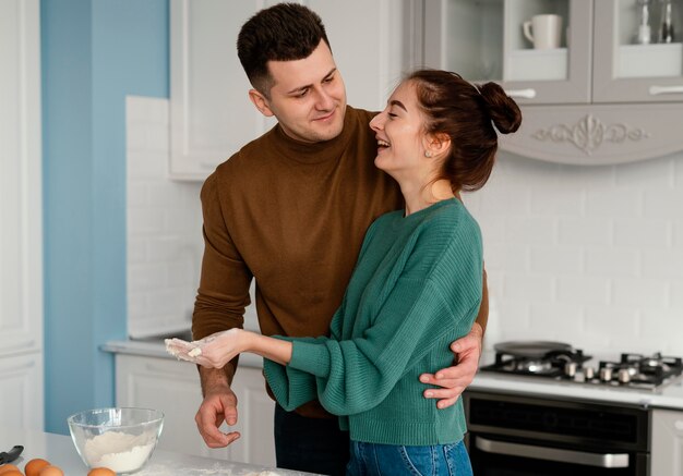 Young couple cooking at home