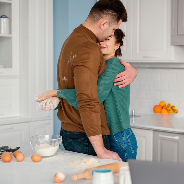 Young couple cooking at home