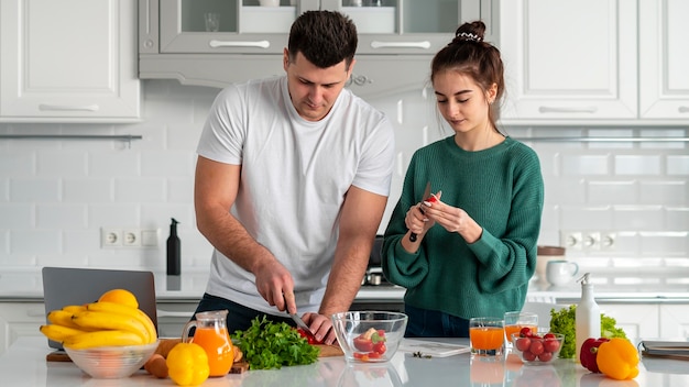 Young couple cooking at home