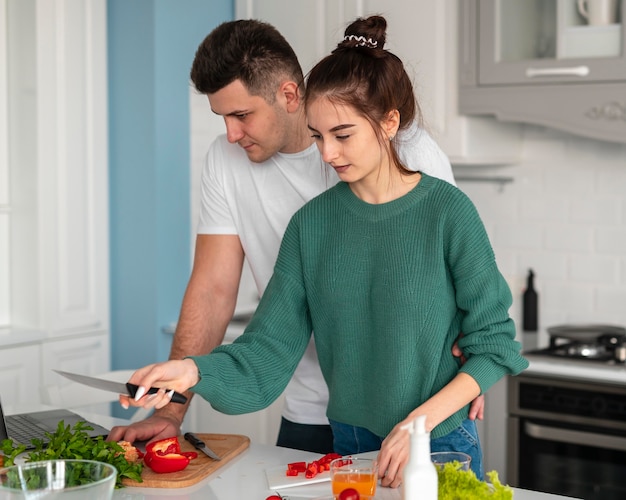 Young couple cooking at home