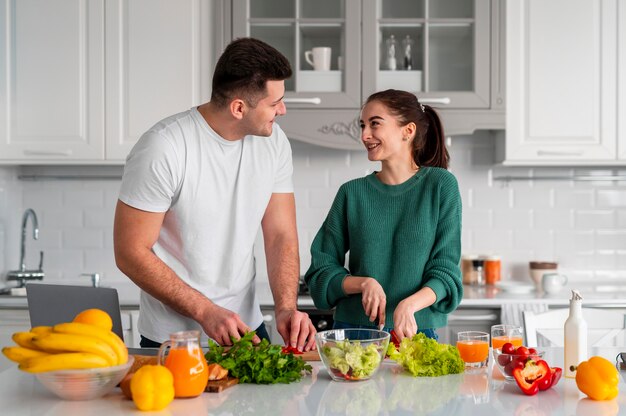 Young couple cooking at home