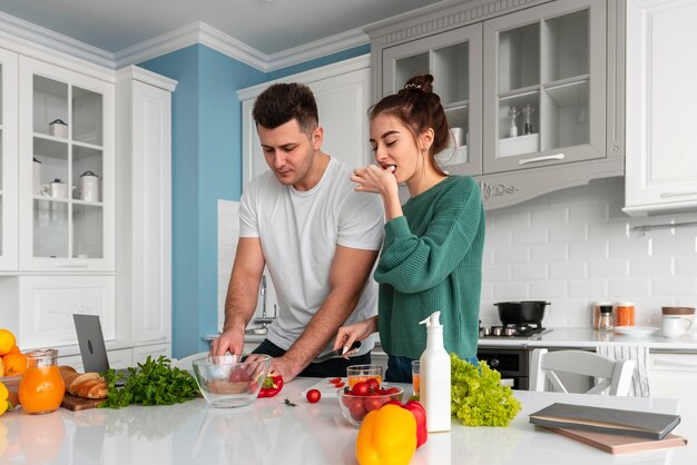 Young couple cooking at home