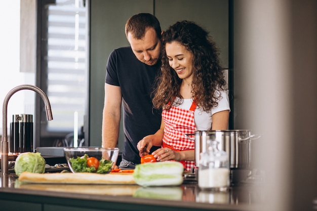 Young couple cooking together at the kitchen