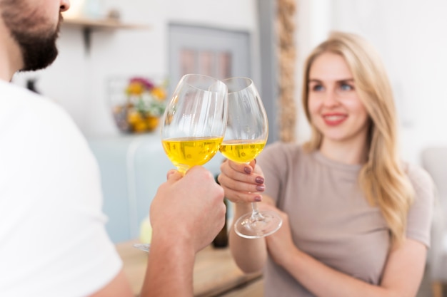 Free photo young couple drinking together form glasses