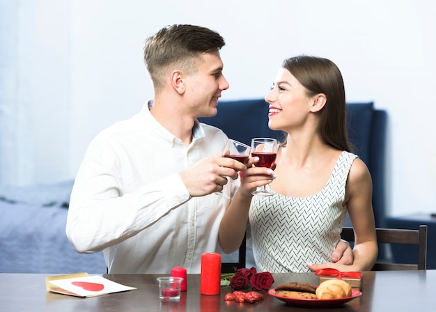 Young couple drinking wine at table 