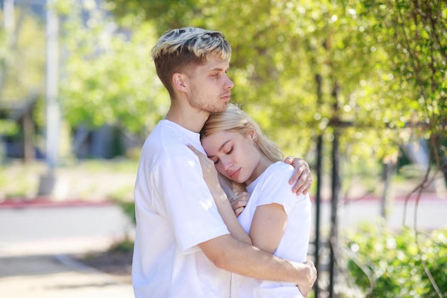 Young couple each other's and the woman put her head on man's chest High quality photo