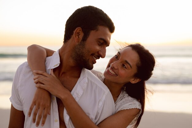 Young couple embracing each other on the beach