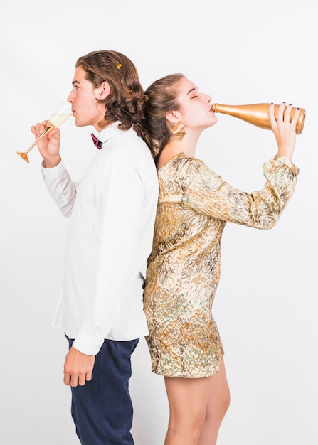 Free photo young couple enjoying champagne at party