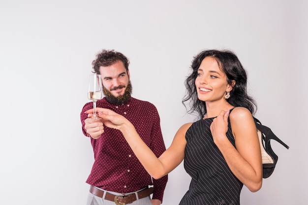 Young couple enjoying sparkling wine at party