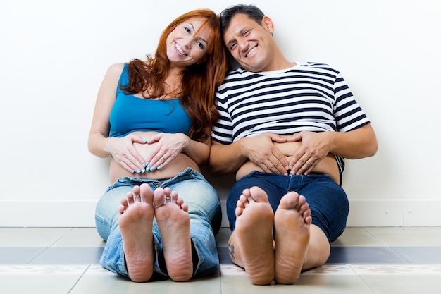 Free photo young couple expecting baby. isolated on white.