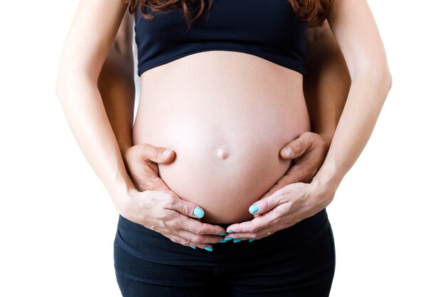 Young couple expecting baby. Isolated on white.