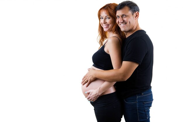 Young couple expecting baby. Isolated on white.