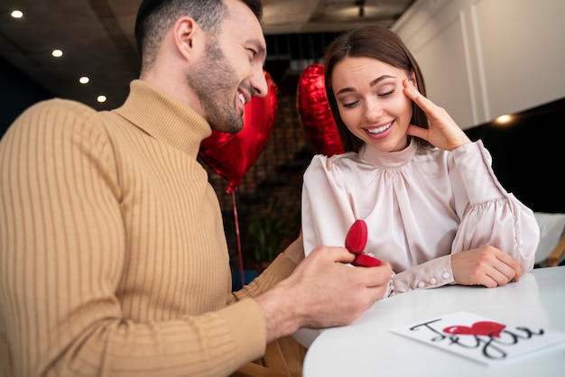 Free photo young couple getting engaged on valentines day