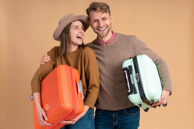 Young couple getting ready for traveling with luggage