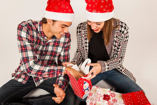 Free photo young couple gifting each other