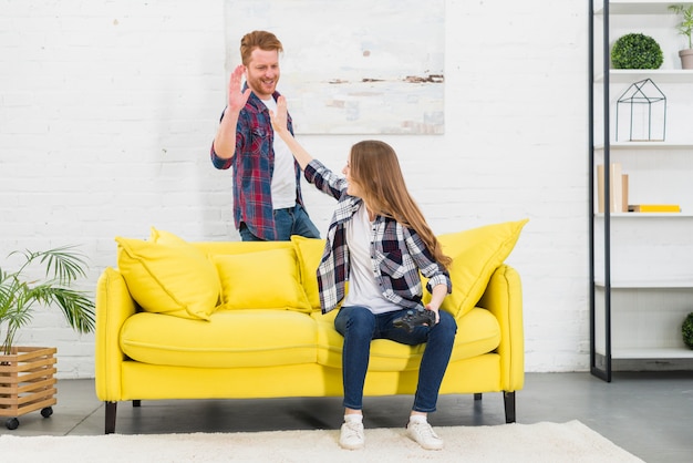 Young couple giving high five to each other after playing the video game