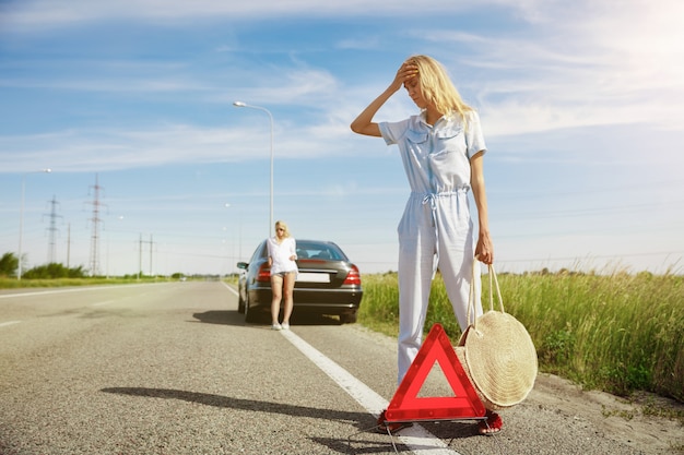 Young couple going to vacation trip on the car in sunny day