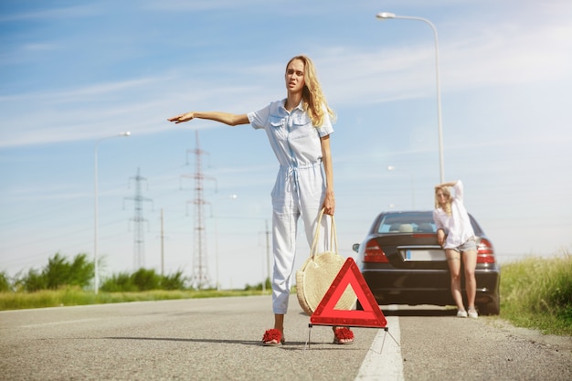 Young couple going to vacation trip on the car in sunny day