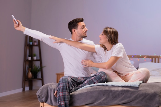 Young couple having fun in bedroom