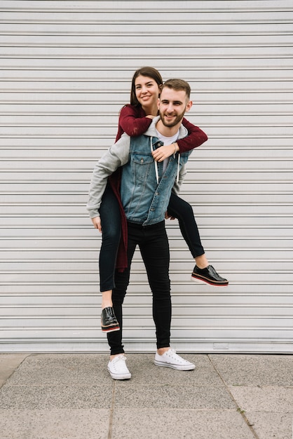 Young couple having fun in front of garage