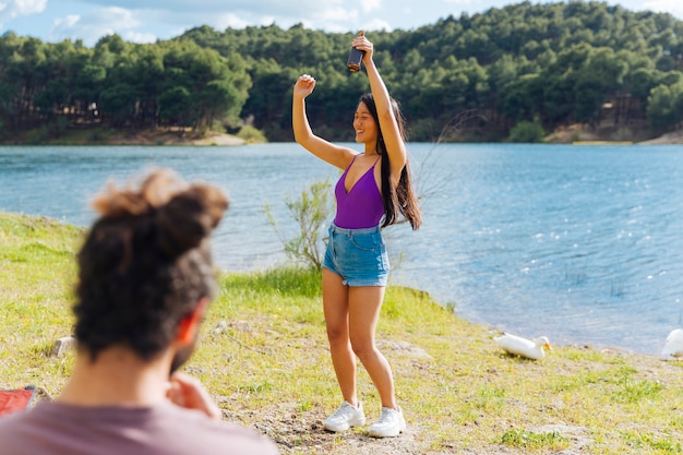 Young couple having fun on riverbank