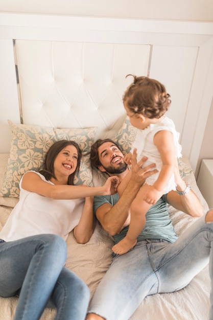 Young couple having fun with daughter