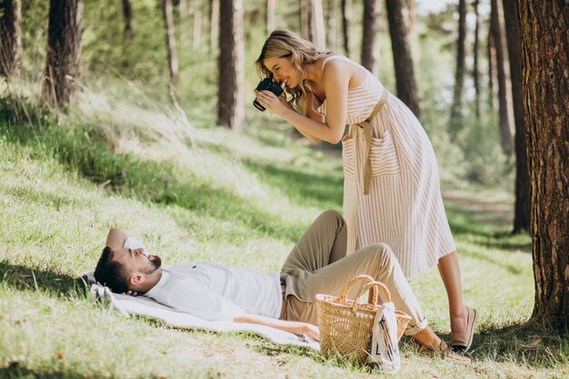 Young couple having picnic in the forest