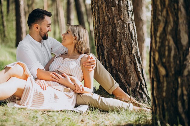 Young couple having picnic in the forest