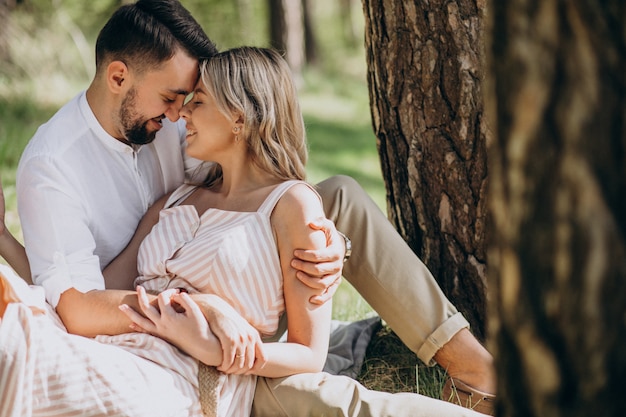 Young couple having picnic in the forest