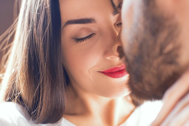 Young couple having romantic evening at home woman reading book