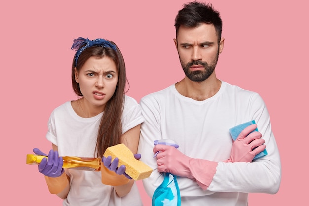 Young couple holding cleaning products