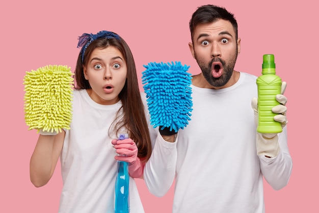 Young couple holding cleaning products