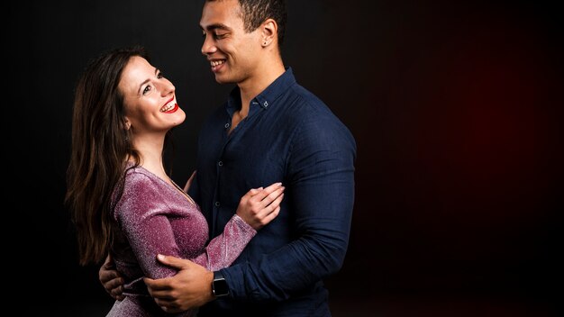 Young couple holding each other for new years eve