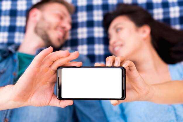 Young couple holding smartphone