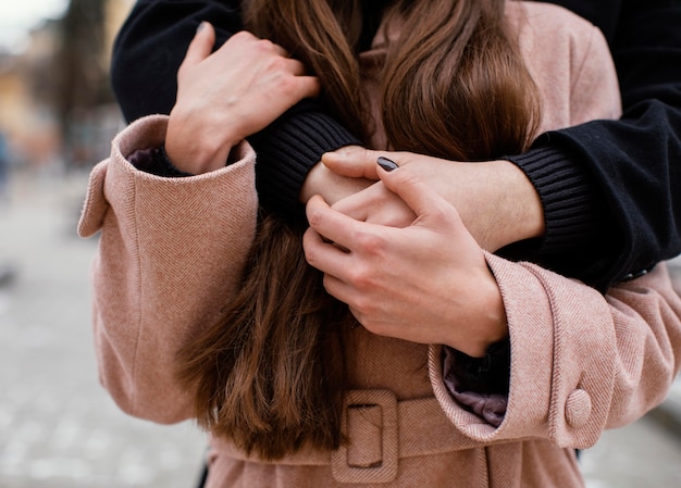 Free photo young couple hugging close up