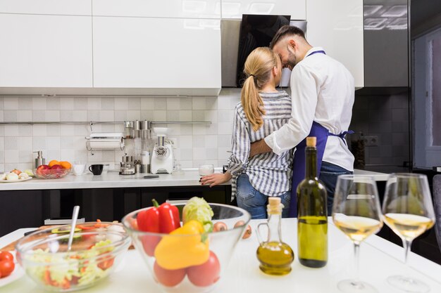 Young couple hugging in kitchen 