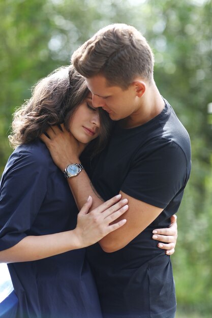 Young couple hugging outdoors