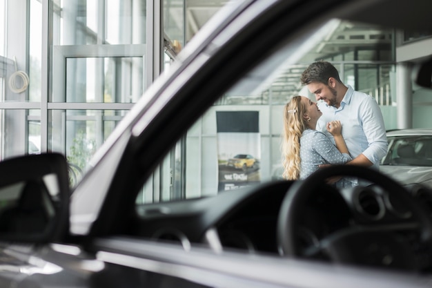 Young couple hugging in a showroom