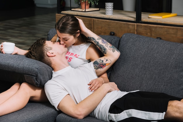 Young couple kissing on couch 