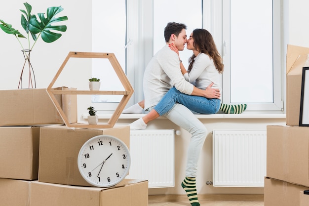 Young couple kissing each other in their new home