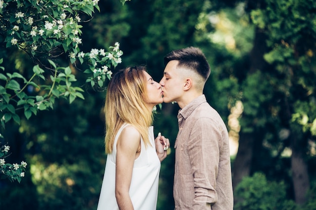 Young couple kissing in green