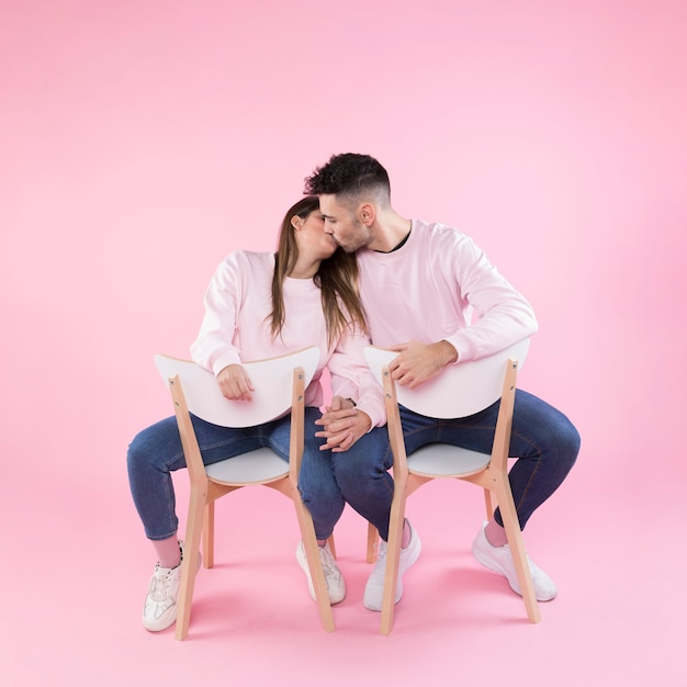 Young couple kissing and holding hands