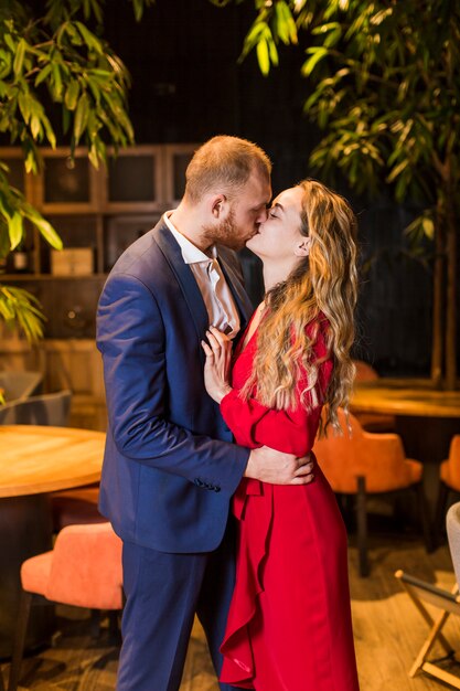 Young couple kissing in restaurant 