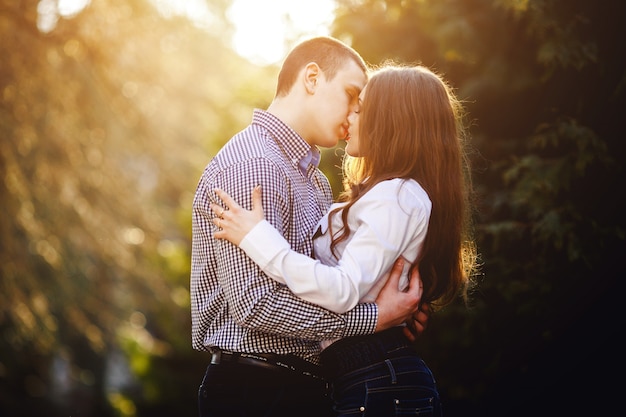 Free photo young couple kissing at sunset