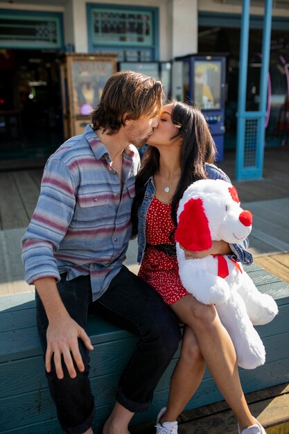 Young couple kissing while on a date at the amusement park