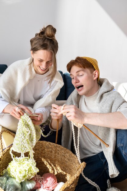 Young couple knitting together