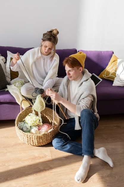 Free photo young couple knitting together